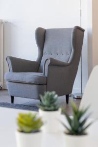 a living room with a couch and a table with plants at Hotel De Belgique à Menton in Menton