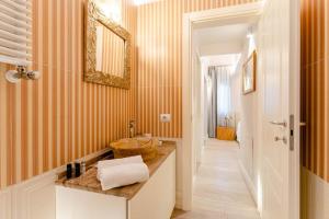 a bathroom with a sink and a mirror at Art Apartment Luxury Sofia Suite in Florence