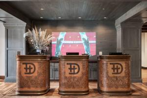 two drums in a room with a tv in the background at Hotel Drover, Autograph Collection in Fort Worth