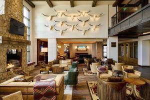 a hotel lobby with couches and a fireplace at Hotel Drover, Autograph Collection in Fort Worth