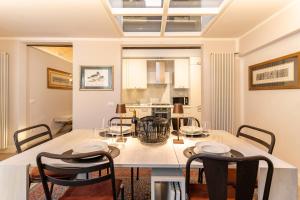 a kitchen and dining room with a table and chairs at Art Apartment Luxury Sofia Suite in Florence