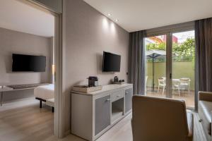 a hotel room with a bed and a tv at SH Colón Valencia in Valencia