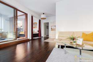a living room with a couch and a glass table at Pineapple Apartments Palais am Neumarkt - 90 qm - 1x free parking in Dresden