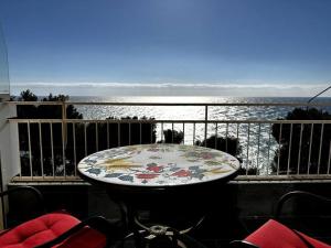 a table on a balcony with a view of the ocean at Suite Fronte Mare - Sanremo in Sanremo