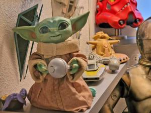 a stuffed baby yoda is sitting on a shelf at The Rufford Hotel in Skegness