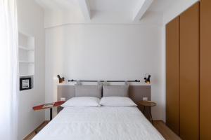 a bedroom with a large bed with white sheets at Olimpico Apartment - Zen Real Estate in Rome