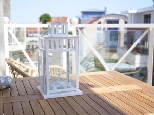 a lantern sitting on top of a table on a balcony at Oceanblue Appartements - Laboe in Laboe