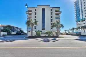 an empty street in front of a building with palm trees at Direct Ocean Front 3BR/2BA Dog Friendly in Myrtle Beach