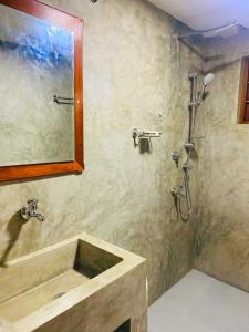 a bathroom with a sink and a shower at The River Villa in Talpe
