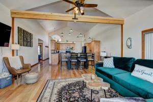 a living room with a couch and a dining room at Twin Pines Cabin in Wilderness Ranch on Hwy 21, AMAZING Views, 20 ft ceilings, fully fenced yard, pet friendly, , Go paddle boarding at Lucky Peak, or snowshoeing in Idaho City and take in the hot springs, sleeps 10! in Boise