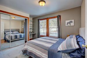 a bedroom with a bed and a sliding glass door at Twin Pines Cabin in Wilderness Ranch on Hwy 21, AMAZING Views, 20 ft ceilings, fully fenced yard, pet friendly, , Go paddle boarding at Lucky Peak, or snowshoeing in Idaho City and take in the hot springs, sleeps 10! in Boise