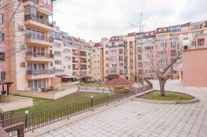 a courtyard in a city with tall buildings at Luxury Studio Apartment - Varna Residens in Varna City