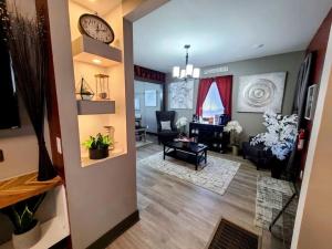 a view of a living room with a clock on the wall at King Bed In Main Floor - Downtown Vacation Rental in Kalamazoo