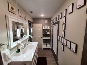a bathroom with a sink and a mirror at King Bed In Main Floor - Downtown Vacation Rental in Kalamazoo