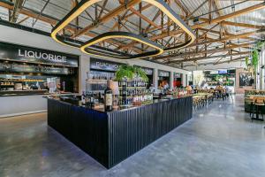 a bar in a restaurant with a lot of bottles of wine at Studios novos em condomínio com foodhall #TopTower in Florianópolis