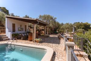 a backyard with a swimming pool and a house at Finca Rural Es Pujol in Sóller