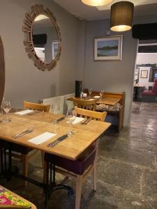 uma sala de jantar com uma mesa e um espelho em The Ilchester Arms Hotel, Ilchester Somerset em Ilchester
