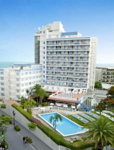 a large hotel with a swimming pool in front of a building at Catalonia Las Vegas in Puerto de la Cruz