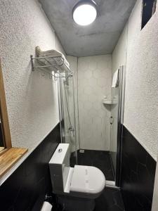 a small bathroom with a toilet and a shower at Corner Hot in Istanbul