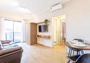 a living room with a couch and a table at Consolação by Charlie in Sao Paulo