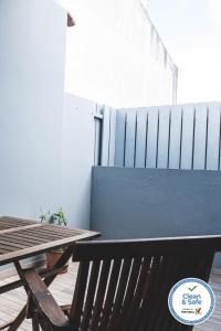 a wooden table and a bench next to a fence at Casa do Vereador in Ponta Delgada