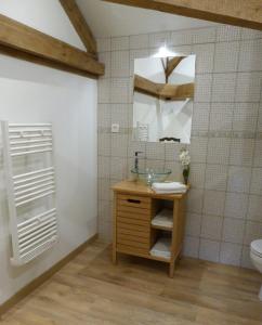 een badkamer met een wastafel en een spiegel bij Logis de L'Arceau in Celles