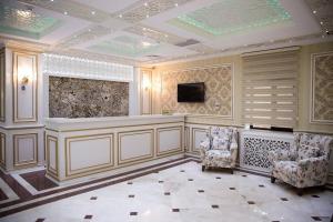 a large room with two chairs and a television at MUGHAN PARK HOTEL in Sabirabad