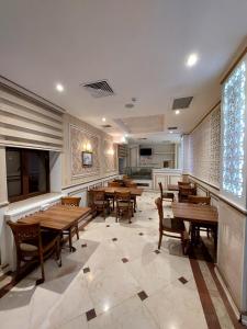 a dining room with wooden tables and chairs at MUGHAN PARK HOTEL in Sabirabad