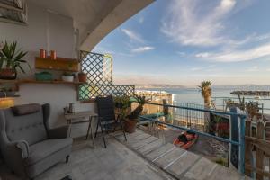a balcony with a view of the water at MareVestrum - incantevole casa con accesso diretto in spiaggia in Bacoli
