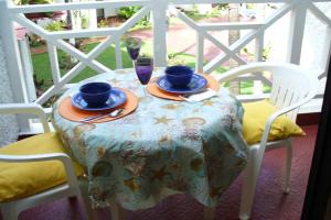 a table with two chairs and a table with a table cloth at Chrisanns Paradise Suite by the Ocean - Apt#9 in Ocho Rios
