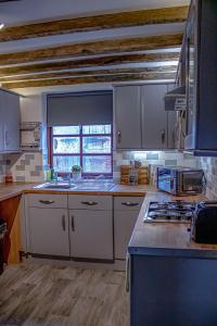 a kitchen with white cabinets and a counter top at Forget me not cottage in Ironbridge