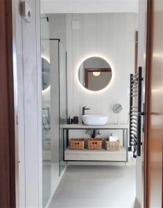 a white bathroom with a sink and a mirror at Boutique Hotel Colina del Emperador in La Manga del Mar Menor