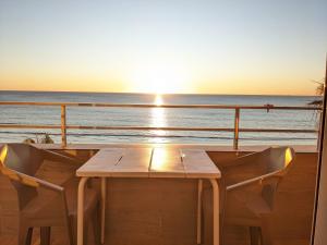 a table on the deck of a cruise ship with the sunset at Apartamento en la playa con garaje in Cádiz