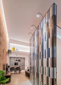 a large glass wall in a room with a dining room at Loft Retiro in Madrid