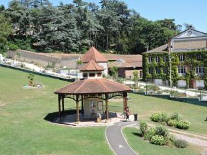 a gazebo in a park next to a building at Appartement Saint-Galmier, 3 pièces, 4 personnes - FR-1-496-276 in Saint-Galmier