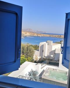 a view from a window of a building with a pool at Villa Euphrosyne in Líndos