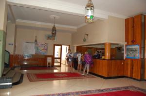 a group of people standing in a lobby at Hotel Les Amandiers in Tafraoute