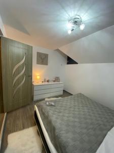 a bedroom with a bed and a ceiling at Mountain escape in Carpathian in Malaia