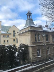 an old building with a tower on top of it at Polska Poduszka in Lviv +140 photos