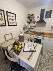 a kitchen with a table with a bowl of fruit on it at El Géiser de Pozuelo in Pozuelo de Aragón