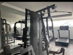 a gym with several tread machines in a room at Gangothri in Trivandrum