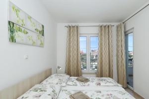 a bedroom with two beds and a window at Apartments Punta in Privlaka +28 photos