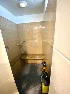 a small bathroom with a tub with a hose at New! Cozy 4-bedroom w/ free parking. Dogs welcome! in Berea +14 photos