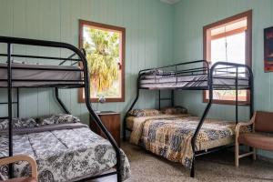 a room with two bunk beds and a window at Cabin mountain view near Ponce slepts 8 in Ponce