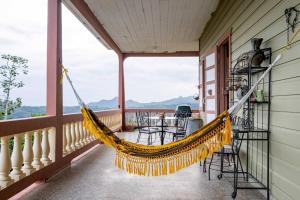 a hammock on the porch of a house at Cabin mountain view near Ponce slepts 8 in Ponce