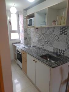 a kitchen with a sink and a counter top at Jujuy 303 in San Miguel de Tucumán