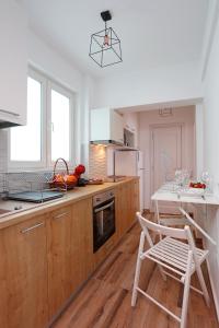 a kitchen with wooden cabinets and a table and chairs at Traditional Romanian Apartments Old Town City in Bucharest