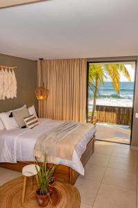 a bedroom with a bed and a view of the ocean at Fishermans Resort Life in La Libertad