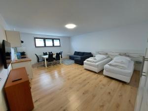 a living room with a couch and a table at Apartments im Taunus in Neu-Anspach