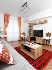 a living room with a couch and a flat screen tv at Traditional Romanian Apartments Old Town City in Bucharest